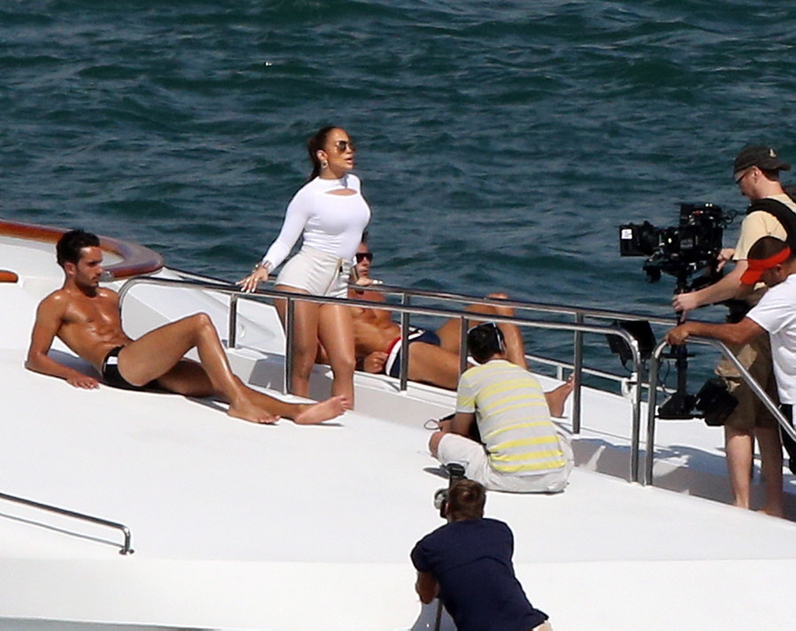 Never mind the half-naked men with the chiseled abs laying out in the sun beside her -- Jennifer Lopez stole the show as she turned her pout to the camera during a video shoot in Miami on Feb. 12, 2014. Never mind the half-naked men with the chiseled abs laying out in the sun beside her -- Jennifer Lopez stole the show as she turned her pout to the camera during a video shoot in Miami on Feb. 12, 2014.