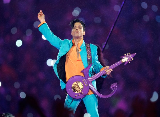 FILE - In this Feb. 4, 2007, file photo, Prince performs during the halftime show at the Super Bowl XLI football game at Dolphin Stadium in Miami. A rare Prince music film, "Sign O' the Times," will air on Showtime beginning Sept. 16. The film was created as an in-theater companion to his 1987 double album of the same name. (AP Photo/Chris O'Meara, File)
