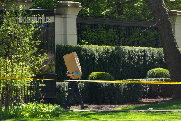Toronto Police investigate a shooting outside the mansion of rapper Drake in Toronto's Bridle Path neighborhood, Tuesday, May 7, 2024. Paramedics said a security guard working outside the home was taken to hospital with serious but non-life-threatening injuries in an overnight shooting. (Nathan Denette/The Canadian Press via AP)