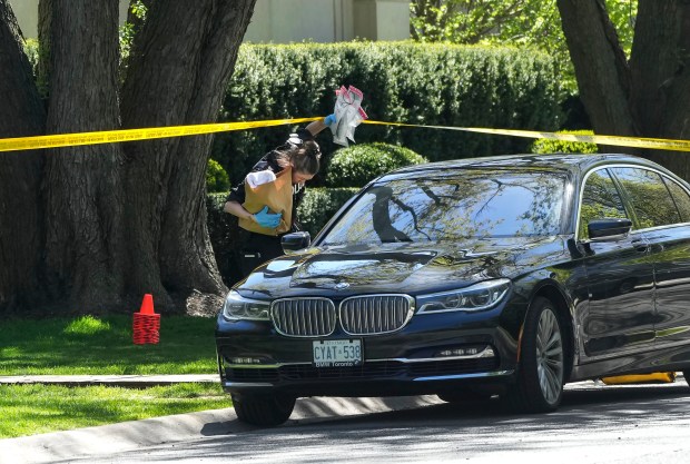 Toronto Police investigate a shooting outside the mansion of rapper Drake in Toronto's Bridle Path neighborhood, Tuesday, May 7, 2024. Paramedics said a security guard working outside the home was taken to hospital with serious but non-life-threatening injuries in an overnight shooting. (Nathan Denette/The Canadian Press via AP)