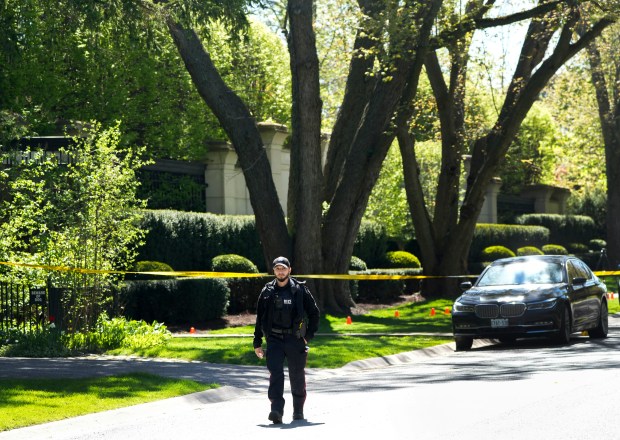 Toronto Police investigate a shooting outside the mansion of rapper Drake in Toronto's Bridle Path neighborhood, Tuesday, May 7, 2024. Paramedics said a security guard working outside the home was taken to hospital with serious but non-life-threatening injuries in an overnight shooting. (Nathan Denette/The Canadian Press via AP)
