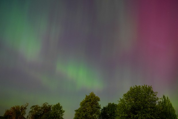 The northern lights, or aurora borealis, are visible over Lake Washington, in Renton, Wash., on Friday evening, May 10, 2024. (AP Photo/Lindsey Wasson)