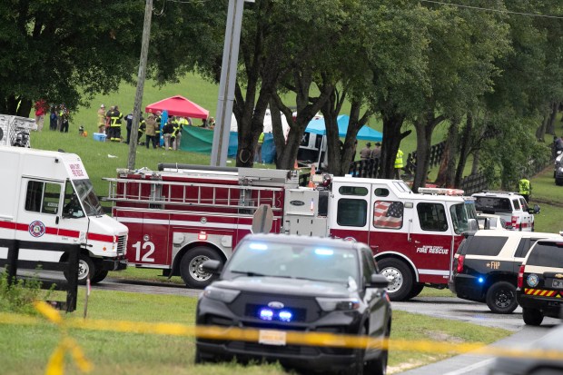Emergency personnel respond to the scene of a deadly crash on Tuesday, May 14, 2024 near Dunnellon, Fla. The Florida Highway Patrol says a bus carrying farmworkers in central Florida has overturned, killing several people and injuring other passengers. (AP Photo/Alan Youngblood)