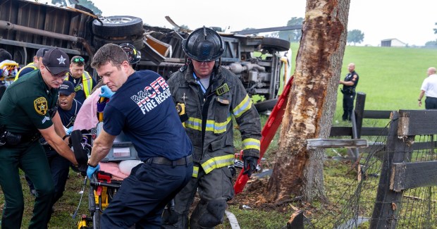 This photo provided by the Marion County Fire Rescue Dept. shows crews from Marion County Fire Rescue and the Marion County Sheriff's Office assisting victims after a bus carrying farmworkers crashed and overturned early Tuesday, May 14, 2024 near Ocala, Fla. The Florida Highway Patrol says eight people were killed and nearly 40 others were injured. (Marion County Fire Rescue Dept. via AP)