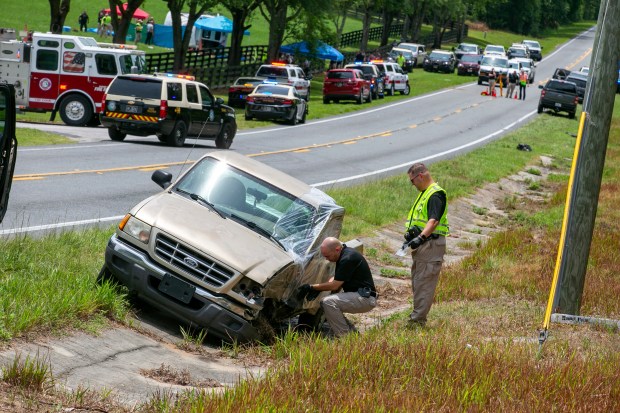 Authorities work at the scene of a deadly crash after a bus carrying farmworkers collided with a pickup truck on State Road 40 Tuesday, May 14, 2024, near Dunnellon, Fla. (AP Photo/Alan Youngblood)