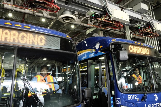MTA brass showed off a pair of new New Venture electric buses Tuesday at the Grand Ave. Depot in Maspeth. (Evan Simko-Bednarski)