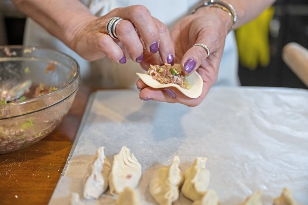 Gretchen McKay places filling in her homemade dumplings before she broils them in her kitchen on Wednesday, April 3, 2024, in Avon. (Benjamin B. Braun/Pittsburgh Post-Gazette/TNS)