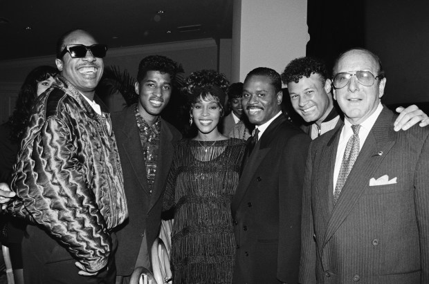 (L-R) Stevie Wonder, Babyface, Whitney Houston, LA Reid, Narada Michael Walden and Clive Davis attend a party circa 1988.