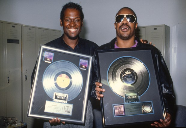 Luther Vandross and Stevie Wonder pose with a platinum record sales plaque for the album 'The Night I Fell In Love' circa 1985. (Photo by Lester Cohen/ Getty Images