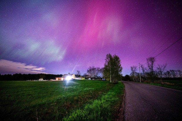 MERCER, MAINE - MAY 11, 2024 The aurora borealis fills the sky with pink and blue waves of color over a farmhouse in Mercer, Maine on May 11, 2024. The aurora borealis, commonly referred to as the northern lights, are electrically charged particles that are interacting with gases in outer space. This recent display was the strongest seen since 2003 rating a G5 on the geomagnetic scale. (Photo by Michael Seamans/Getty Images)