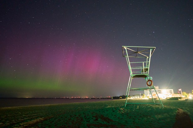 The Northern lights or aurora borealis illuminate the night sky at the beach in Grand Bend, Ontario, Canada, during a geomagnetic storm on May 12, 2024. The most powerful solar storm in more than two decades struck Earth on May 10, 2024, triggering spectacular celestial light shows in skies from Tasmania to Britain -- and threatening possible disruptions to satellites and power grids as it persists into the weekend. Auroras are often observed in Canada's northern regions, but rarely in southern Ontario. (Photo by Geoff Robins / AFP) (Photo by GEOFF ROBINS/AFP via Getty Images)