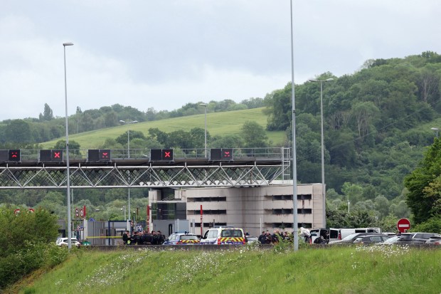 Police officers gather at the site of a ramming attack which took place late morning at a road toll in Incarville in the Eure region of northern France, on May 14, 2024. Two French prison officers were killed and two others wounded on May 14 in an attack on a prison van transporting an inmate who escaped, a police source told AFP. (Photo by ALAIN JOCARD / AFP) (Photo by ALAIN JOCARD/AFP via Getty Images)