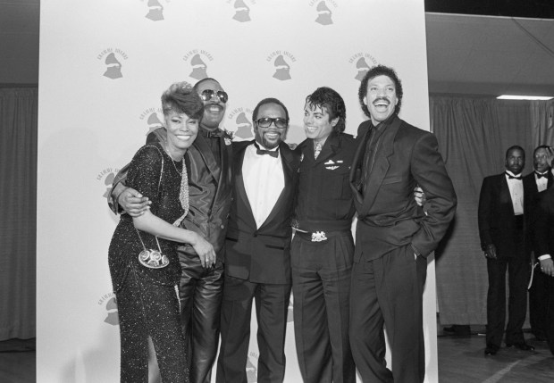 (L-R) Dionne Warwick, Stevie Wonder, Quincy Jones, Michael Jackson, and Lionel Richie congratulate each other after "We Are The World" won 4 Grammy Awards circa 1986.