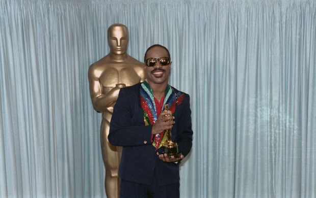 Stevie Wonder, who began learning the piano at the age of seven, holds his Oscar award for the category of Best Song in 1985 for "I Just Called to Say I Love You."