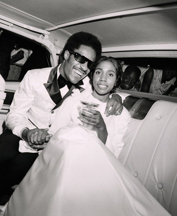 (Original Caption) 9/13/70- DETROIT: Singing star Stevie Wonder embraces his bride, the former Syreeta Wright, a Motown songwriter and songstress, as they depart Detroit's Bernette Baptist Church 9/12 following their wedding ceremony. Following a reception in a downtown Detroit club, the newly-weds left for a Bermuda honeymoon. AC/HO