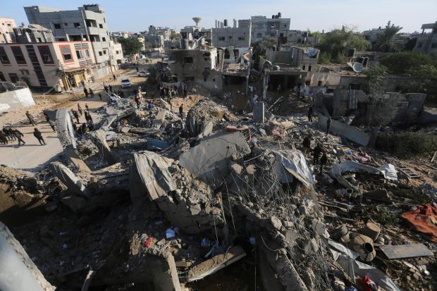 Palestinians look at the destruction by the Israeli bombardment of the Gaza Strip in Rafah, Monday, Dec. 4, 2023. (AP Photo/Hatem Ali)