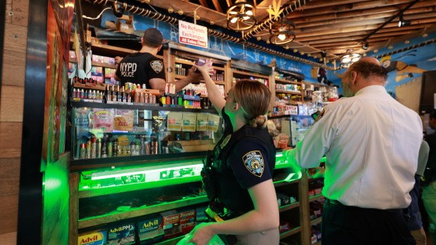 Members of the NYPD CRT Unit and New York City Sheriff's Office are pictured conducting a raid on the New City Smoke Shop on Church St. and Park Pl. in lower Manhattan on Tuesday, May 7, 2024. (Luiz C. Ribeiro for New York Daily News)