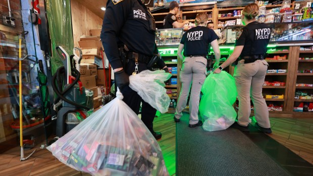 Members of the NYPD CRT Unit and New York City Sheriff's Office are pictured conducting a raid on the New City Smoke Shop on Church St. and Park Pl. in lower Manhattan on Tuesday, May 7, 2024. (Luiz C. Ribeiro for New York Daily News)