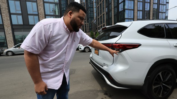Bronx driver Eufelix Jiminian points to bullet holes in his Toyota Highlander after a passenger opened fire at his cab at around 4 a.m. on May 3. During a press conference in the Bronx with Fernando Mateo and members of the New York State Federation of Taxi Drivers, Mr. Jiliminian described his ordeal and fears in Spanish. Video footage from inside the car showed the driver, 26-year-old Eufelix Jiminian, jumping when the shots were fired from the right side of the passenger door. The passenger fired five shots before escaping. (Luiz C. Ribeiro for NY Daily News)