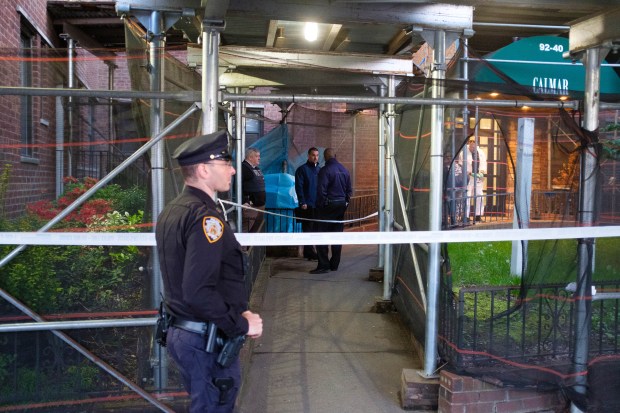 Police investigate after a body was discovered in the bushes outside an apartment building at 92-40 Queens Boulevard in Queens on Sunday, May 12, 2024.