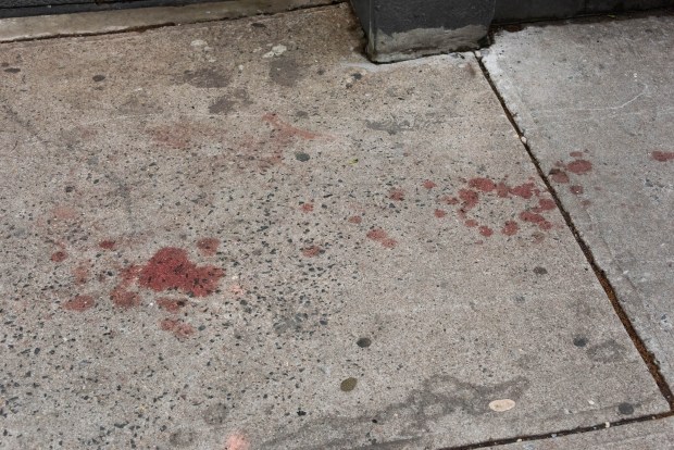 Blood is seen on the sidewalk on W. 147th St. in Harlem on Sunday. (Gardiner Anderson for New York Daily News)