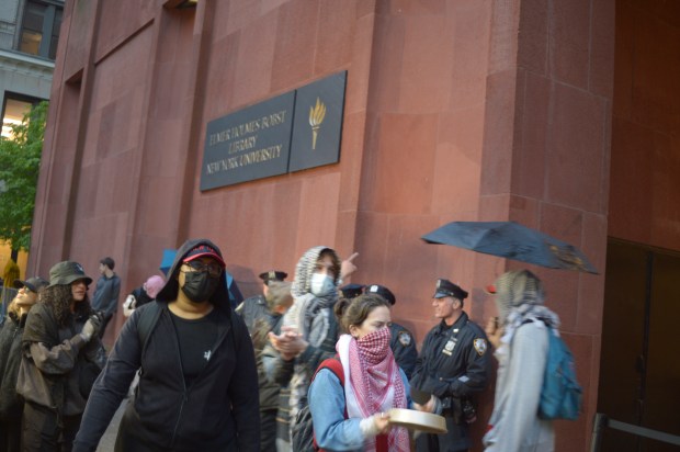 Protesters march in front of NYU's Elmer Holmes Bobst Library on Friday, May 10, 2024. NYPD police officers monitored the protesters. (Sam Costanza for the New York Daily News)(Sam Costanza for the New York Daily News)