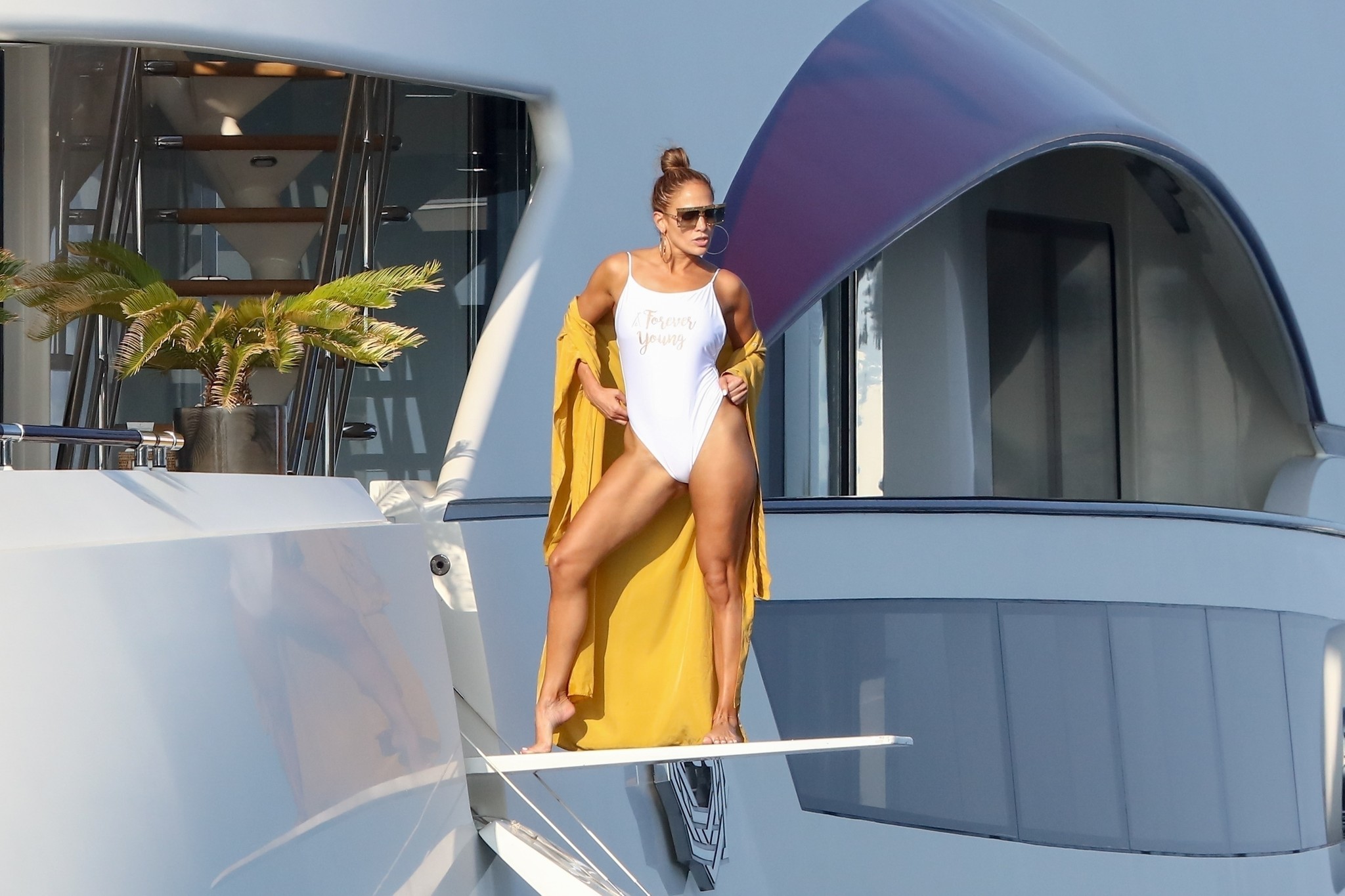 Jennifer Lopez poses for a photoshoot on a diving board on the deck of her yacht off St. Tropez during a trip with fiance Alex Rodriguez on Sept. 3, 2019. Jennifer Lopez poses for a photoshoot on a diving board on the deck of her yacht off St. Tropez during a trip with fiance Alex Rodriguez on Sept. 3, 2019.